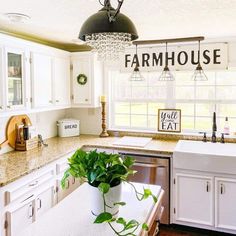 a kitchen with a potted plant on the counter and a sign that says farmhouse