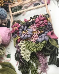 a pile of yarn sitting on top of a table next to a birdcage