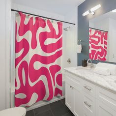 a bathroom with pink and white shower curtains