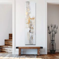 an abstract painting hangs on the wall next to a wooden bench and vase with flowers