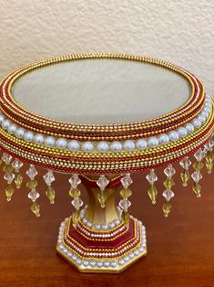 an elaborately decorated mirror sits on a table