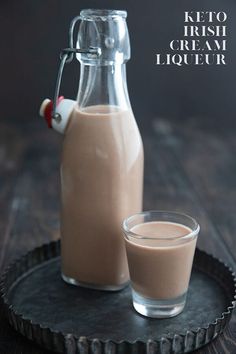 two glasses and a bottle of keto irish cream liquer on a tray