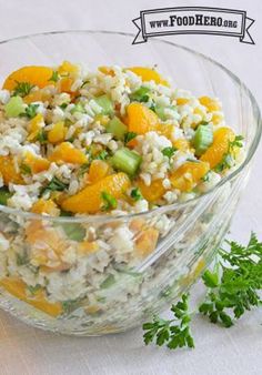 a glass bowl filled with rice and vegetables