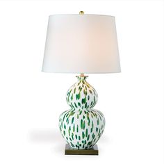 a green and white lamp with a shade on it