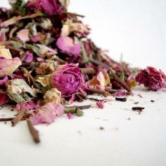 a pile of dried flowers sitting on top of a white table