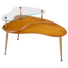 a wooden and glass coffee table with two legs on each side, in the shape of an ostrich's foot