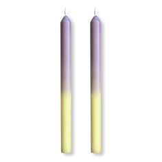 two candles with yellow and purple lights on them