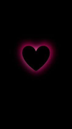 a black background with a pink heart in the center and an orange light behind it