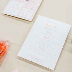 the wedding stationery is laid out on the table