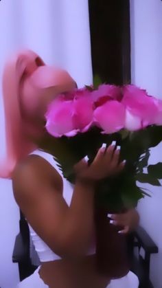 a blurry image of a woman holding flowers