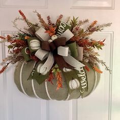 a fall wreath hanging on the front door