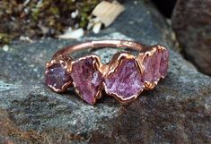 Great ring with applied raw rhodolite crystals, which were set in copper using electroforming. Each ring is shipped in eco-friendly gift packaging. You will receive the ring pictured above or a comparable one. ---------------------------------------------------------------------------------------------------------- Rhodolite | raw rhodolite ring | Rhodolite Crystal | Electroformed | Copper Ring | Raw rhodolite crystals have been electroformed into a hand hammered copper ring. Every stone is as u Bohemian Rings With Raw Stone For Healing, Bohemian Raw Stone Rings For Healing, Bohemian Raw Stone Healing Rings, Bohemian Rings With Raw Stone, Unique Crystal Ring With Raw Stone For Promises, Rhodolite Ring, Raw Garnet, Environmentally Friendly Gifts, Tiny Studio