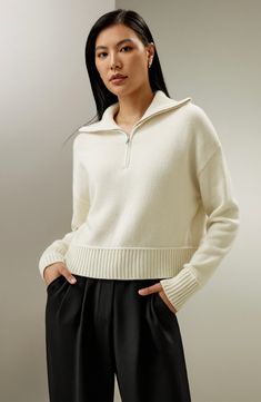 Crafted from a blend of 70% wool and 30% cashmere, this pullover features dropped shoulder sleeves, large lapels, and ribbed cuffs and hem. It's versatile for wearing alone in early autumn or layering under a trench or coat in winter. 70% Wool+30% Cashmere Lapel Collar Loose Fit Half Zip-Up Ribbed Cuffs and Hems Chic Wool Sweater With Ribbed Collar, Chic Wool Polo Sweater For Winter, Chic Winter Wool Polo Sweater, Winter Workwear Cashmere Cropped Sweater, Chic Cashmere Polo Sweater For Winter, Wool Tops With Ribbed Neckline For Fall, Chic Cashmere Top With Ribbed Collar, Chic Cashmere Polo Sweater, Chic Cashmere Tops With Ribbed Collar