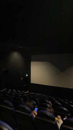 an empty theater with people sitting in the seats