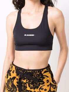 Black/white logo-print sports bra from JIL SANDER featuring logo print to the front, cropped, scoop neck, racerback, sleeveless and straight hem. Just a reminder that this piece must be tried on over your own garments.. | Jil Sander Logo-Print Sports Bra Sporty Seamless Nylon Crop Top, Sporty Scoop Neck Elastane Crop Top, Sporty Elastane Tank Top, Black Nylon Crop Top For Sports, Black Nylon Sporty Crop Top, Cropped Sports Bra With Medium Support, Black Sporty Nylon Crop Top, Black Nylon Sports Crop Top, Sporty Black Nylon Crop Top