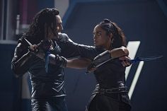 an image of two people that are in the same pose with swords on their hands