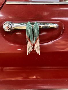 a door handle with tassels and beads hanging from it's center piece