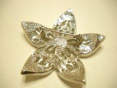 "Vintage 1960s silver tone metal, star-shaped brooch. 2\" x 2'. Loaded with aurora borealis and clear rhinestones, all of which are present and intact. Gorgeous sparkle! Standard working clasp. Excellent condition. Unsigned." Silver Star Brooch For Gift, Silver Star-shaped Brooch, Metal Star, Clear Rhinestones, Aurora Borealis, Star Shape, Vintage 1960s, Brooches, Aurora