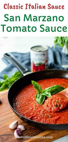 a skillet filled with tomato sauce and basil leaves