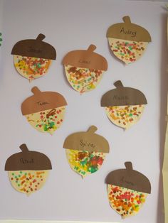 the paper cutouts have different shapes and words on them, including acorns