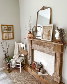 a living room filled with furniture and a fire place under a mirror on top of a mantle