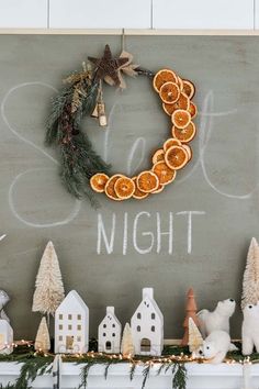 a chalk board with orange slices on it and christmas decorations in front of it that says sale night