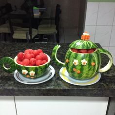 two watermelon teapots with fruit in them on a kitchen counter top