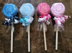 three lollipops with bows on them are lined up next to each other