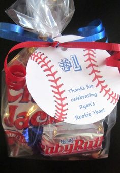 a baseball ornament is wrapped in plastic and tied to a ribbon with the number 16 on it