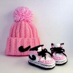 two crocheted shoes and a knitted hat