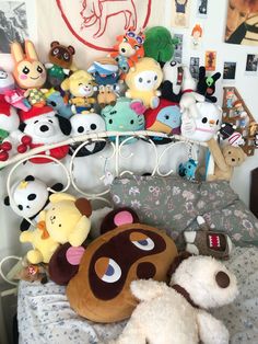 there are many stuffed animals on the bed