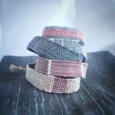 several different colored bracelets stacked on top of each other