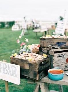 an assortment of food sitting on top of wooden crates