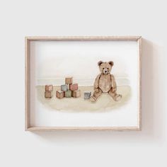 a watercolor painting of a teddy bear sitting on the ground next to cubes