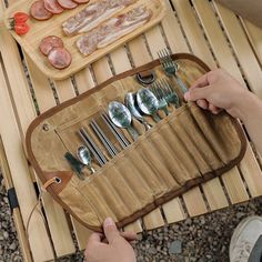 a person is sitting at a table with utensils