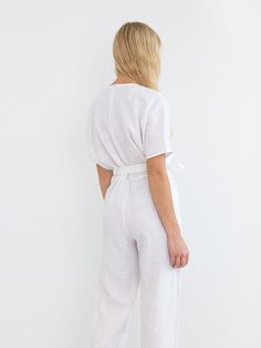 "AURORA is a short sleeve jumpsuit with belt. DETAILS - Wrap style top - Dolman sleeves - Self tie belt - 100% lightweight European linen fabric - Cut and sewn to order just for you in our studio COLOR - White, you can also choose other colors above - Fabric samples are available here https://www.etsy.com/listing/586569696/linen-fabric-samples SIZING & FIT - Fits true to size - Inseam is approximately 28.5 inches / 72 cm - Bust is approximately 21 inches / 49.5 cm - Waist is approximately 18 Solid Color Short Sleeve Relaxed Fit Jumpsuits And Rompers, Relaxed Fit Solid Jumpsuits And Rompers With Short Sleeves, Relaxed Fit Short Sleeve Jumpsuits And Rompers, Belted Short Sleeve Jumpsuits And Rompers For Work, Short Sleeve Belted Jumpsuits And Rompers For Work, White Belted Jumpsuits And Rompers For Summer, Short Sleeve Jumpsuits And Rompers For Workwear, Belted Short Sleeve Jumpsuits For Work, White Belted Jumpsuit For Summer