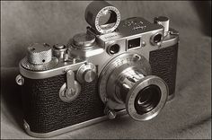 an old fashioned camera sitting on top of a table