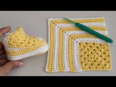 a crocheted yellow and white dishcloth next to a pair of green scissors