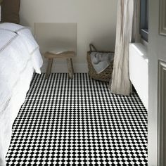 a black and white checkered floor in a bedroom