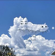 an image of a cloud shaped like a crocodile with eyes and teeth on it's face