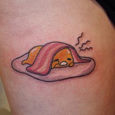 a cartoon character is sleeping in a hot dog bun tattoo on the right side of the thigh