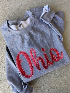 These Ohio sequin sweatshirts are super comfy as well as the perfect touch with boots and jeans!  Sweatshirts are unisex and the sweatshirt color can be changed!  ❗️Sizes: Toddler-2T-5T  Youth XS-XL  Adult S-XL  Adult 2X- Adult 3X  The graphite heather gray sweatshirt has a red sequin Ohio stitched onto the sweatshirt. If you would like to request a custom order, please send us a message!! Long Sleeve Cotton Sweatshirt With Glitter Print, Casual Long Sleeve Sweatshirt With Glitter Print, Fall Sequin Long Sleeve Sweatshirt, Cotton Glitter Print Long Sleeve Sweatshirt, Casual Long Sleeve Glitter Print Sweatshirt, Sequin Long Sleeve Sweatshirt For Fall, Casual Glitter Print Long Sleeve Sweatshirt, Sequined Long Sleeve Fall Sweatshirt, Fall Cotton Tops With Sequins