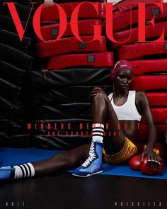 a woman sitting on the ground with boxing gloves