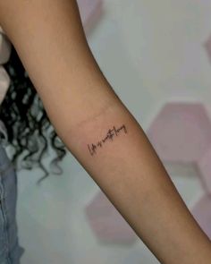 a woman's arm with the word love written in cursive writing on it