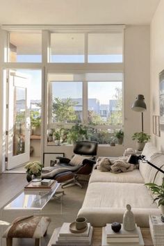 a living room filled with furniture and lots of windows