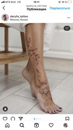 a woman's foot with flowers on it and the bottom part of her leg