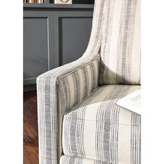 a striped chair in front of a book shelf