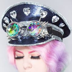 The Party Is The Love Of Your Life With The Destiny Bond Sequin Captain Hat From Lasr. These Glam Rave Festival Hats Feature A Full-On Black Sequin Captain Style Hat With A Gem-Encrusted Front, Removable Kaleidoscopic Spike Goggles, And Elastic Chin Strap To Keep That Hat On While You're Partying Til' The Sun Comes Up. Music Will Never Break Your Heart! "Destiny Bond Sequin Captain Hat Rhinestone, Metal Studs Accents Heart Gem Brouch-Like Decors Sequin Fabric In The Back Removable Spiked Kaleido Fun Brimmed Costume Hats For Parties, Fun Mini Cap Hats For Party, Punk Style Party Cap Hat, Multicolor Cap Costume Hat For Party, Multicolor Cap-shaped Party Costume Hat, Punk Style Adjustable Mini Hats For Parties, Multicolor Brimmed Mini Hats For Party, Fitted Mini Party Cap, Fitted Mini Cap For Party