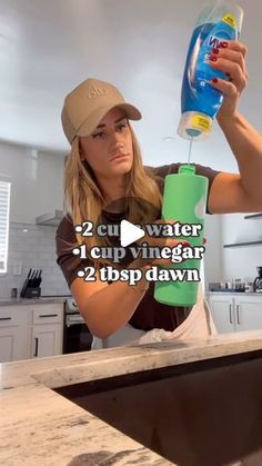 a woman is pouring water into a cup