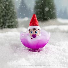 a toy elf is sitting in the snow